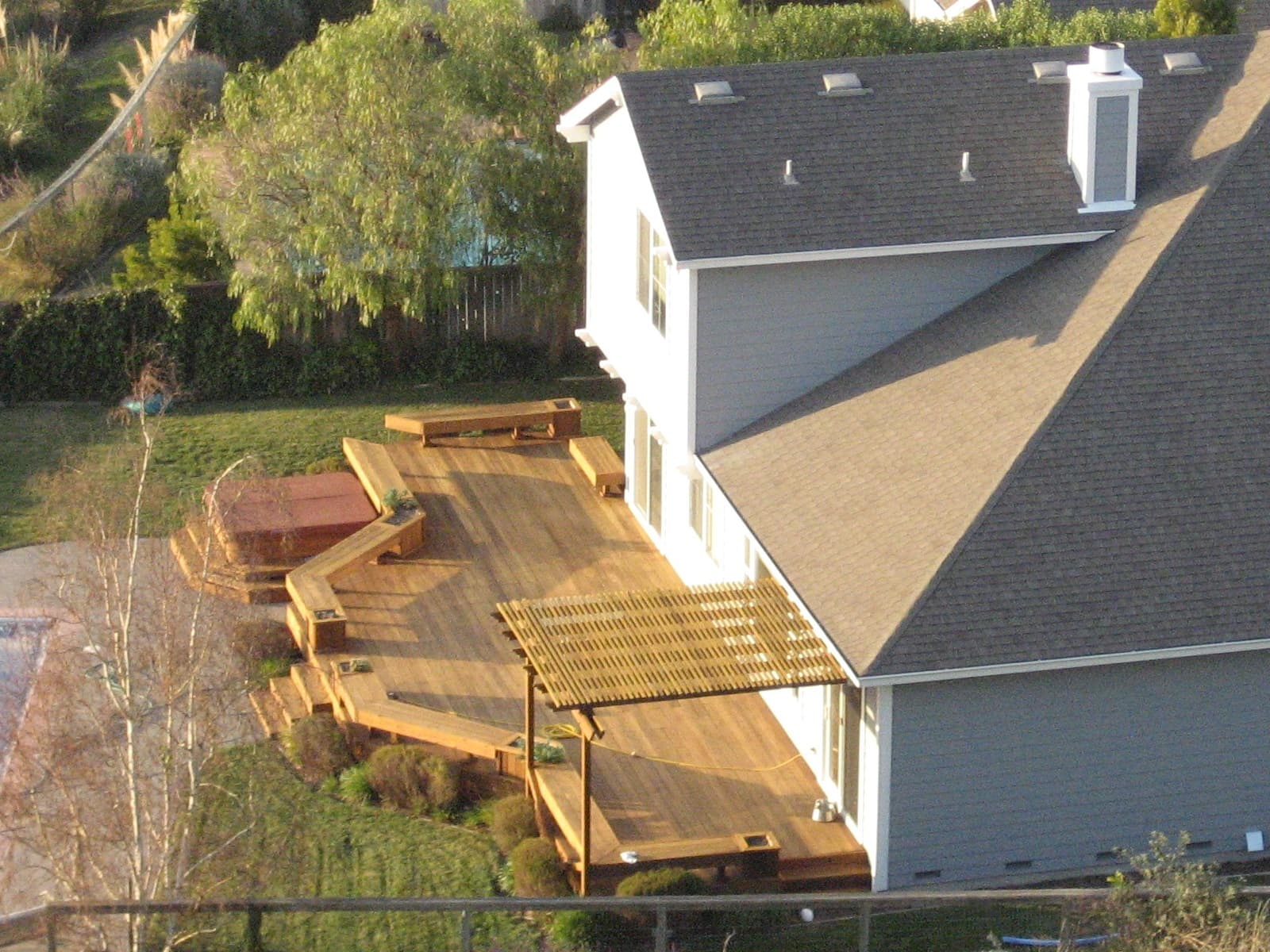 A backyard timber deck beside a house